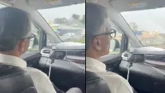 Minister Krishna Byre Gowda meets with DCs while sitting in the car during the trip