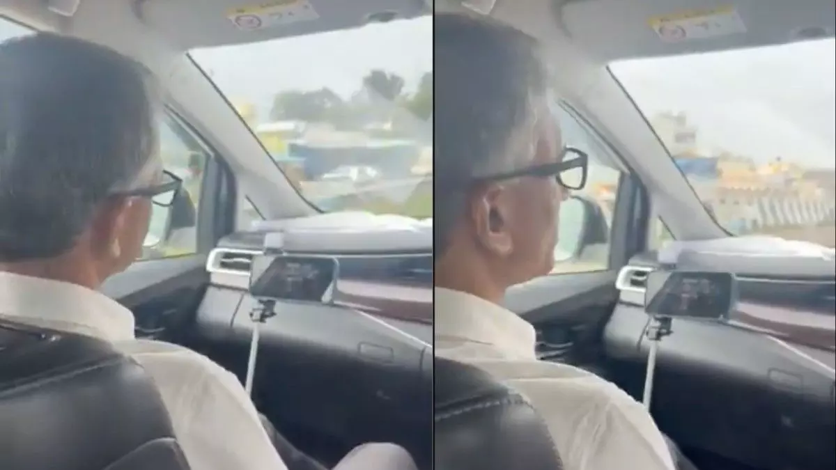 Minister Krishna Byre Gowda meets with DCs while sitting in the car during the trip